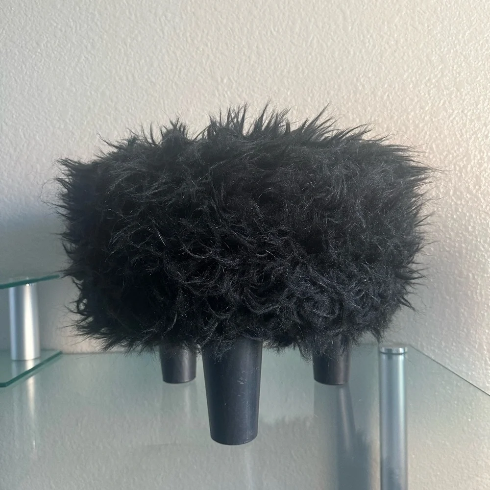black faux fur ottoman/stool with 3 wooden legs